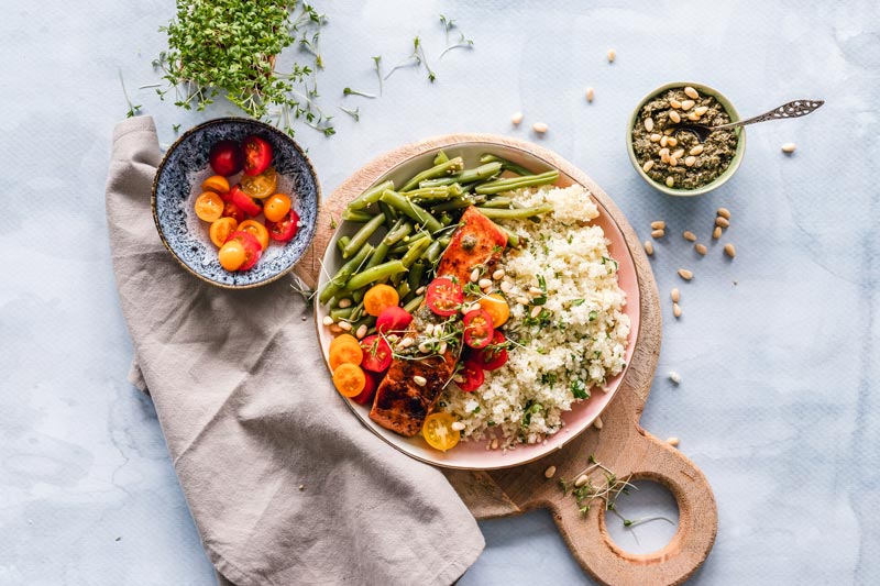 Healthy and nutritious meal of salmon couscous, tomatoes, green beans